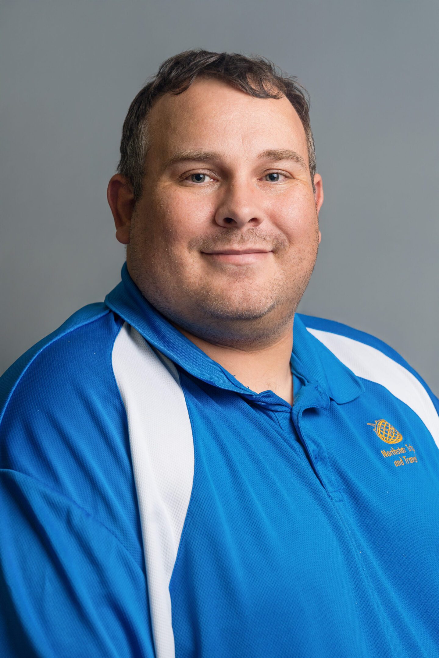 Portrait of a man in a blue sports shirt.